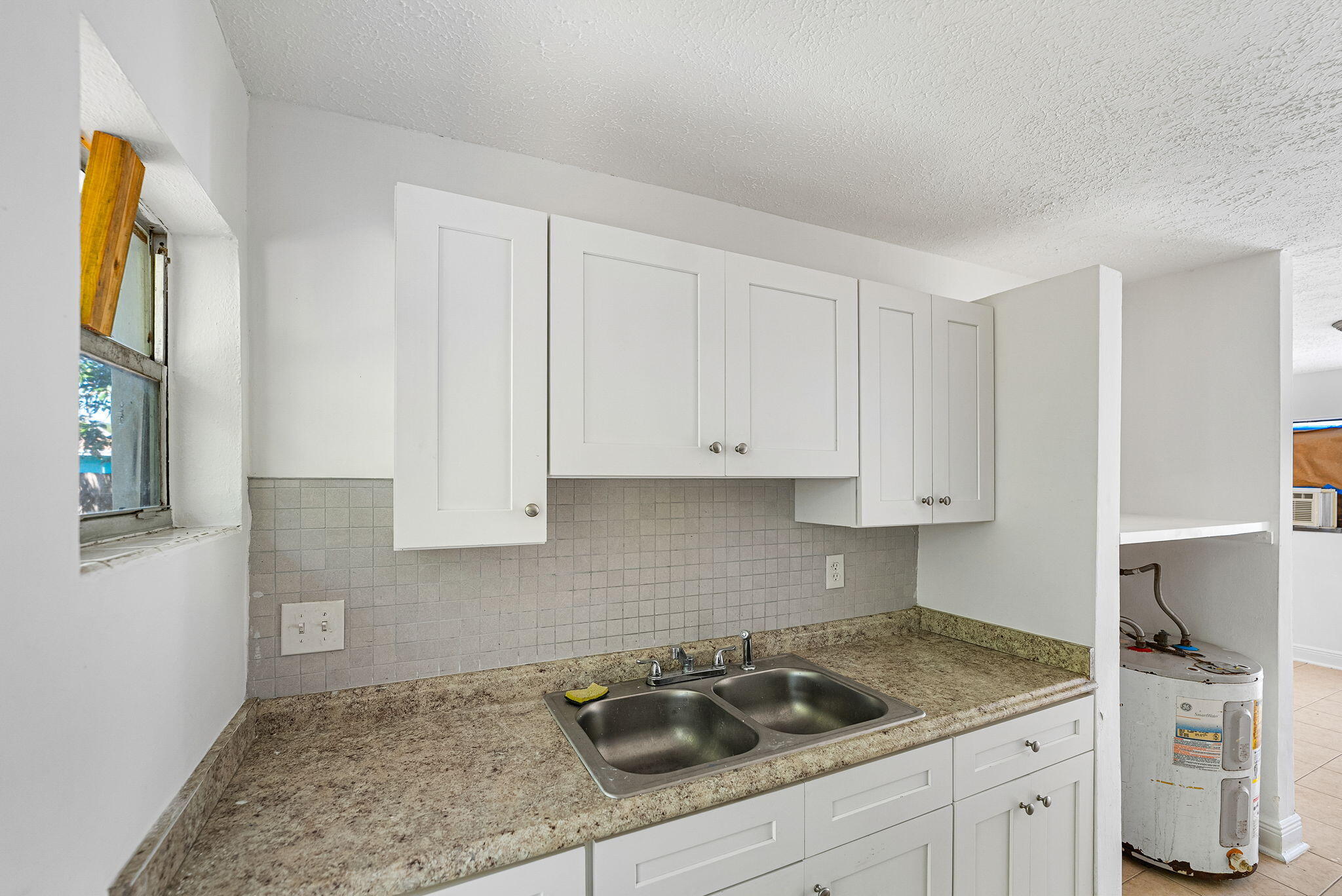 2108 Avenue East Fort Pierce, FL 34950 - Photo 25 of 32 a kitchen with a sink stove and cabinets