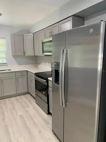 a kitchen with appliances cabinets and a sink