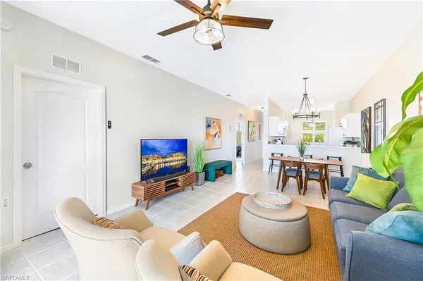 a living room with furniture and a chandelier