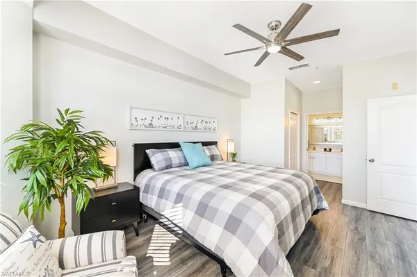 a bedroom with a bed and a potted plant