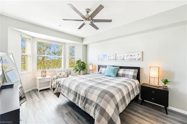 a bedroom with a large bed and a large window