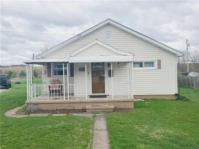 a front view of a house with a yard and porch