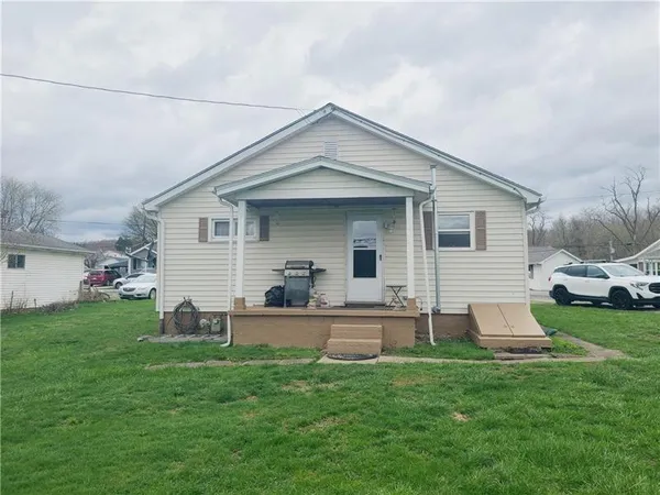 a front view of house with a garden