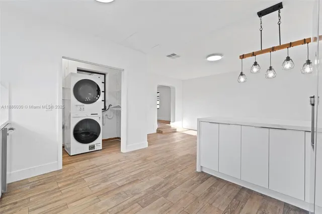 a view of a hallway with washer and dryer