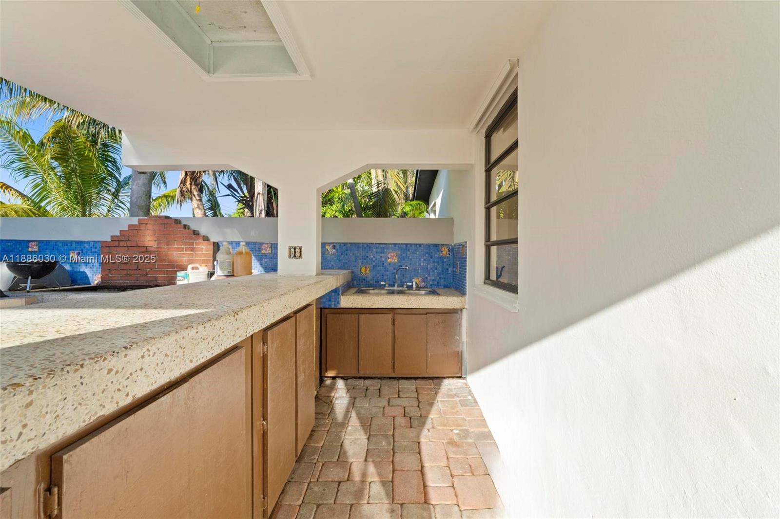 705 East 9th Lane Hialeah, FL 33010 - Photo 18 of 37 a kitchen with stainless steel appliances granite countertop a sink and a stove