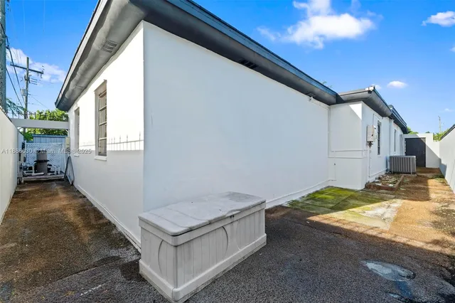 an empty room with wooden floor and window