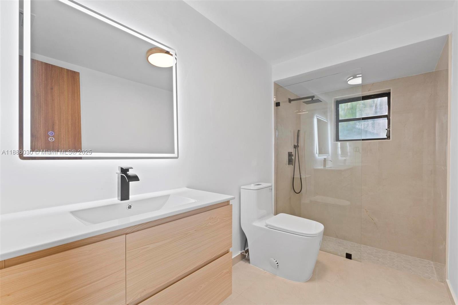 705 East 9th Lane Hialeah, FL 33010 - Photo 25 of 37 a bathroom with a sink a toilet and shower