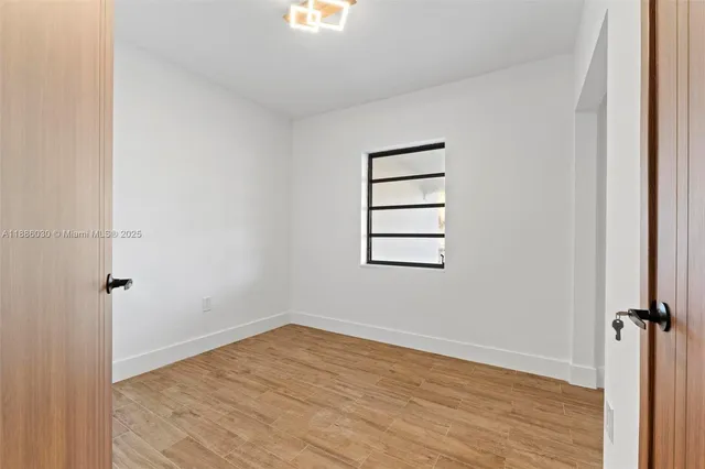 a view of a room with wooden floor and closet