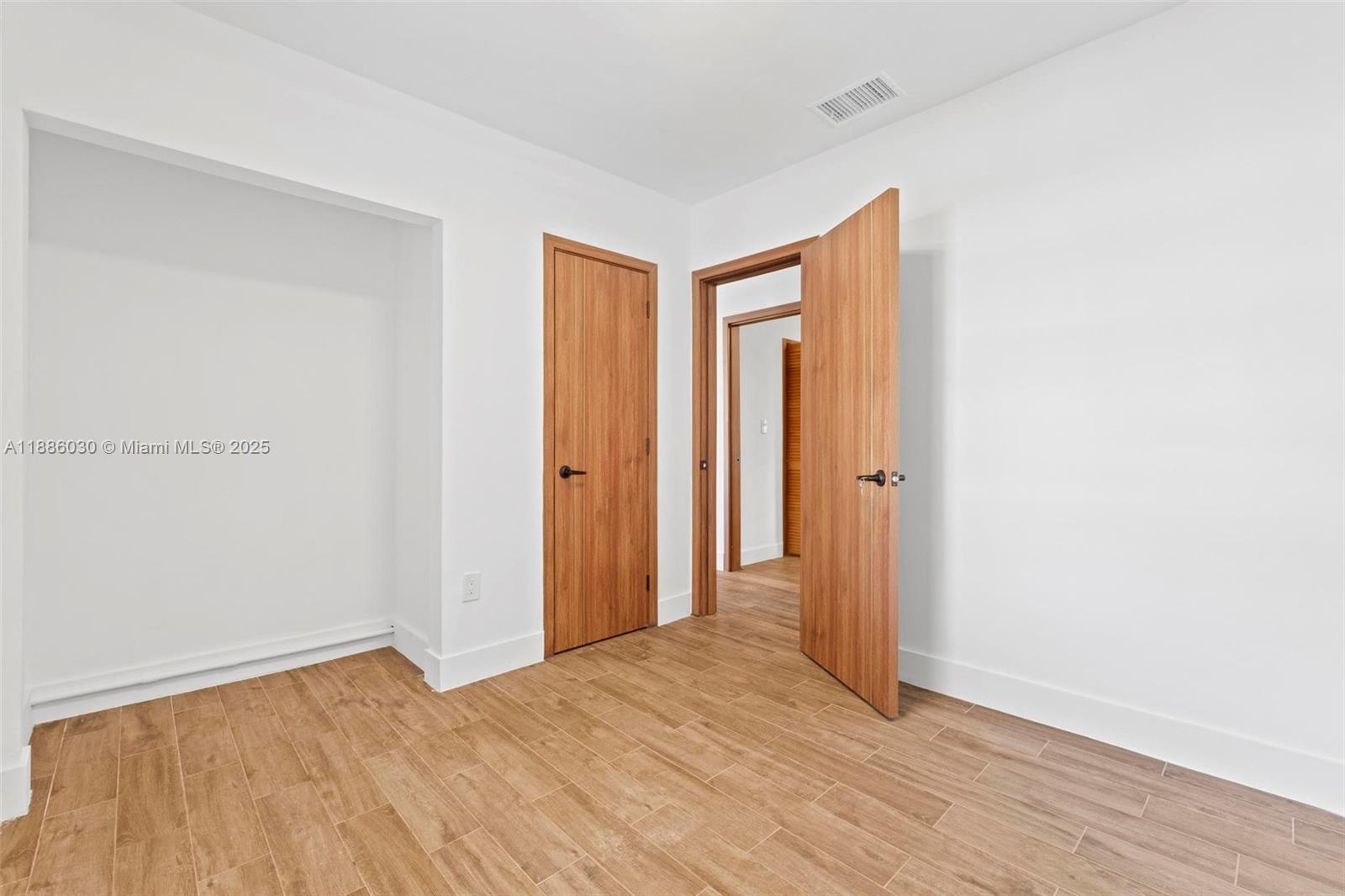705 East 9th Lane Hialeah, FL 33010 - Photo 30 of 37 a view of a room with wooden floor and closet