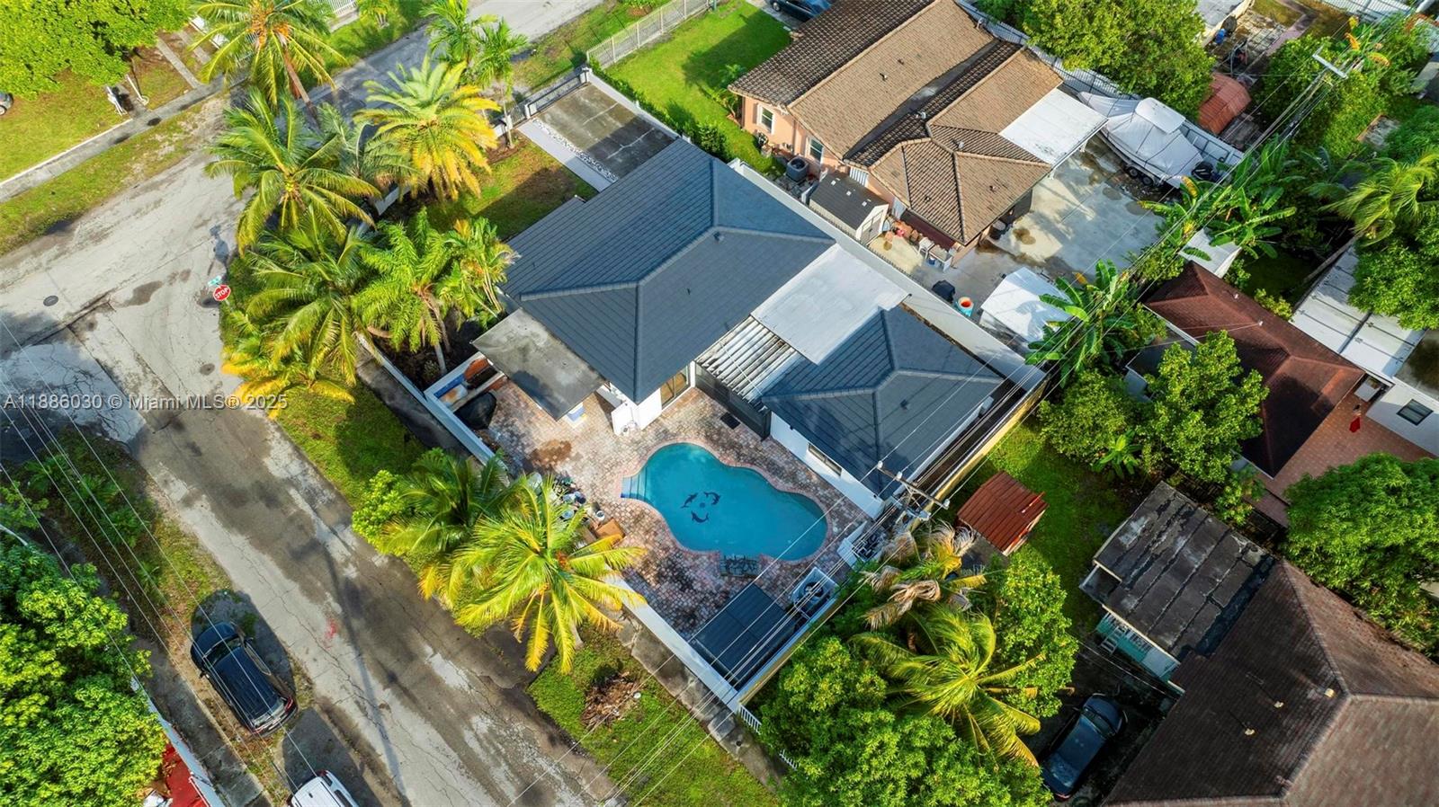 705 East 9th Lane Hialeah, FL 33010 - Photo 33 of 37 an aerial view of a house with a yard and wooden fence