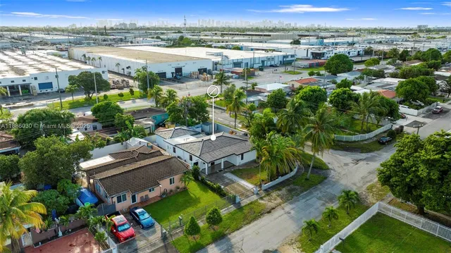 an aerial view of a house with a yard