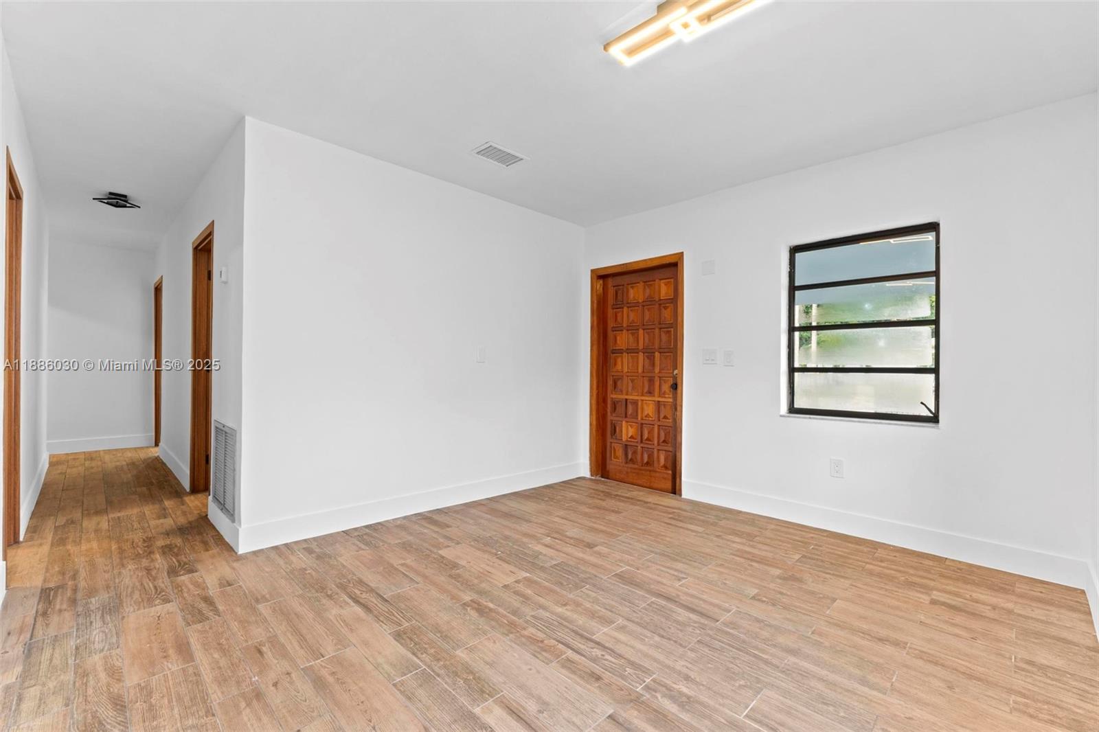 705 East 9th Lane Hialeah, FL 33010 - Photo 6 of 37 a view of livingroom with hardwood floor and a ceiling fan