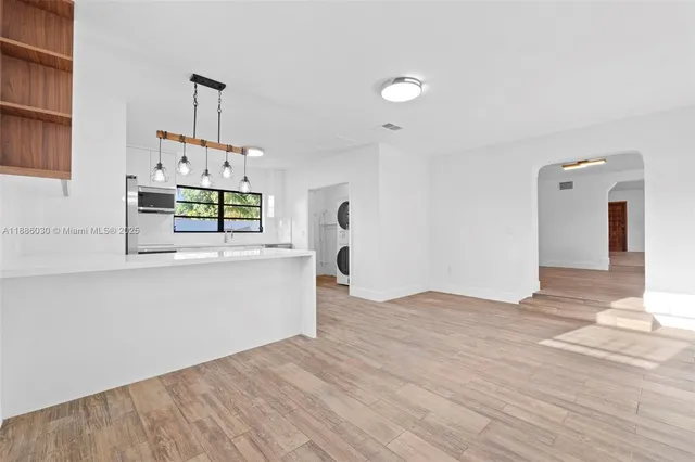 a view of a kitchen with microwave and cabinets