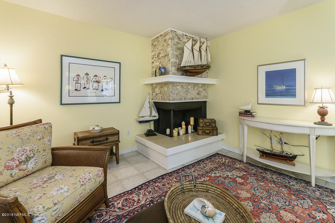 1767 Seminole Road Atlantic Beach, FL 32233 - Photo 10 of 36 a living room with furniture and a fireplace