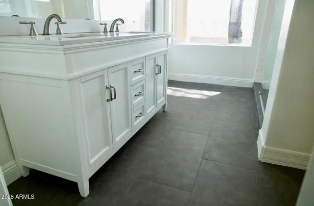a bathroom with a sink and a mirror