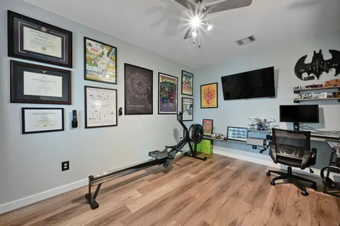 a view of a livingroom with workspace and a window