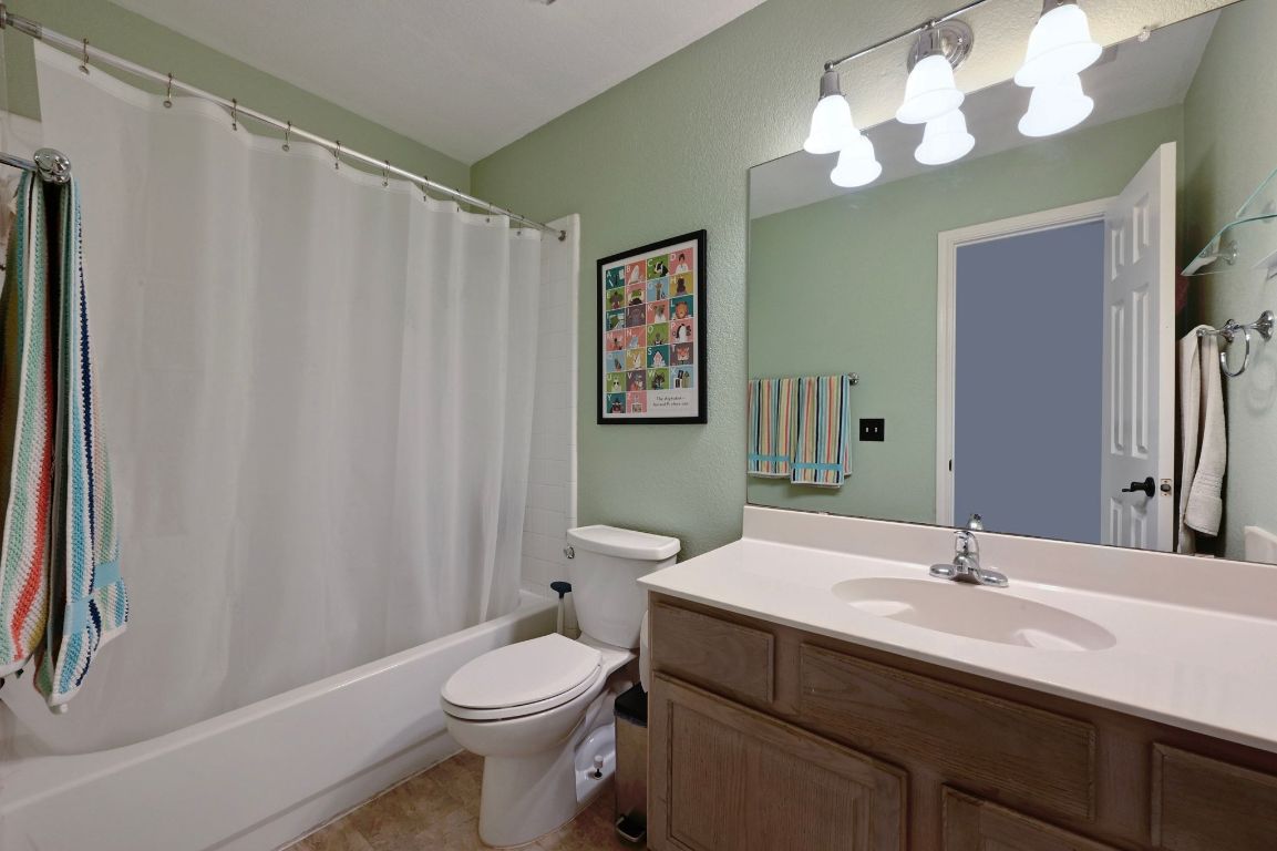 6609 Oasis Drive Austin, TX 78749 - Photo 22 of 27 a bathroom with a sink a toilet and a mirror