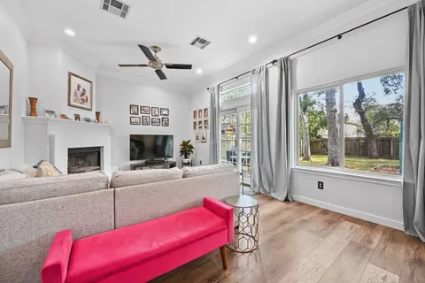 a living room with furniture fireplace and a large window
