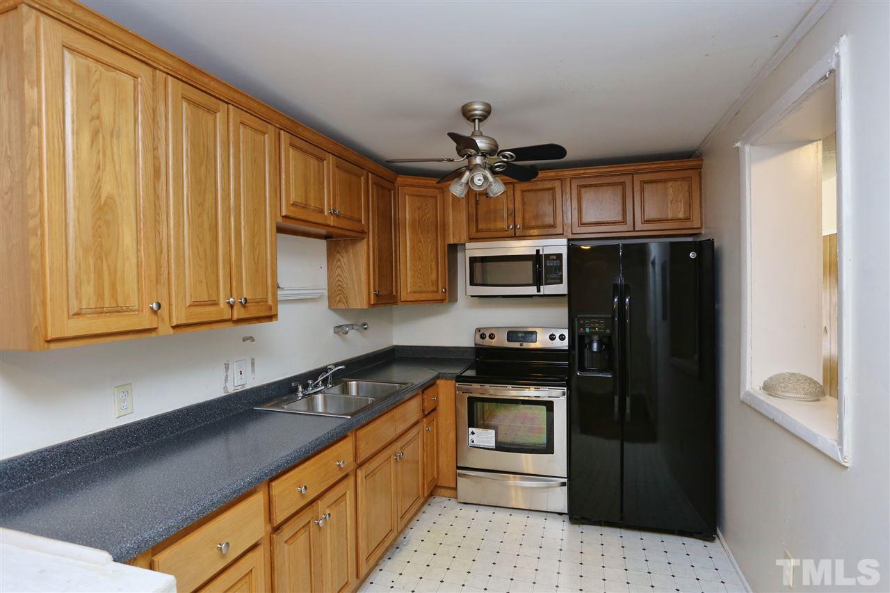706 Fitzgerald Drive Raleigh, NC 27610 - Photo 5 of 10 a kitchen with stainless steel appliances granite countertop a refrigerator a stove top oven a sink and dishwasher