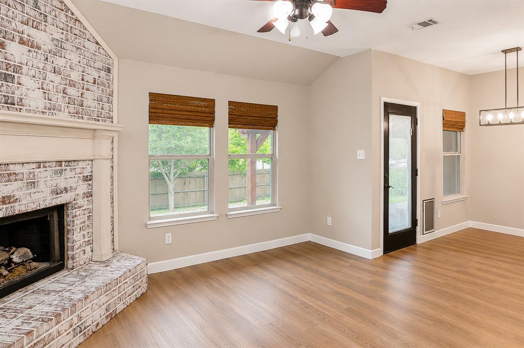 1070 Shepard Lane Lavon, TX 75166 - Photo 9 of 29 a view of an empty room with wooden floor fireplace and a window