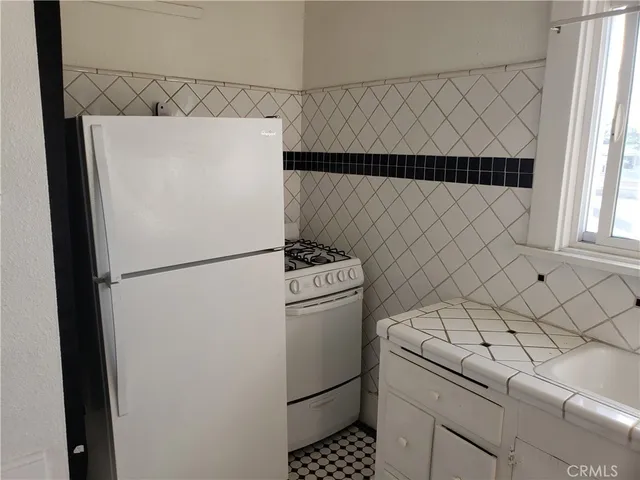 a white refrigerator freezer and a dishwasher