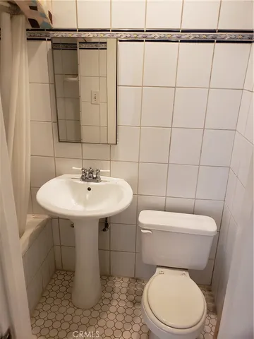 a white toilet sitting next to a bathroom sink