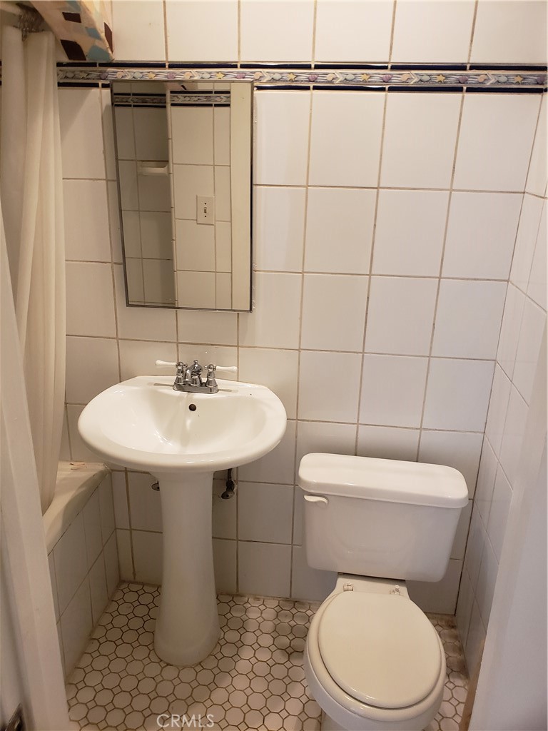 323 West 4th Street, Unit 304 Long Beach, CA 90802 - Photo 21 of 30 a white toilet sitting next to a bathroom sink