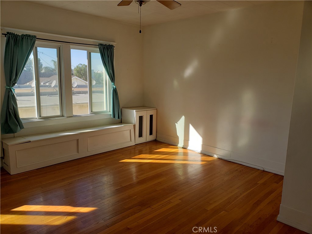 323 West 4th Street, Unit 304 Long Beach, CA 90802 - Photo 4 of 30 a living room with wooden floor and large window