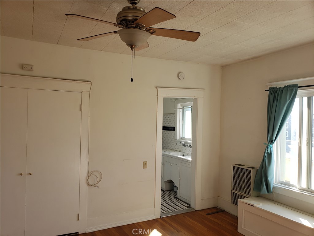 323 West 4th Street, Unit 304 Long Beach, CA 90802 - Photo 9 of 30 a view of empty room with wooden floor and fan