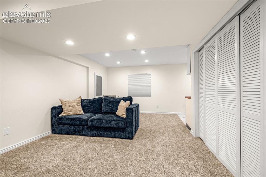 9127 Oakmont Road Peyton, CO 80831 - Photo 31 of 49 a living room with couches and kitchen view with wooden floor