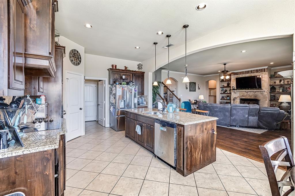 3206 Meadow Ridge Drive Midlothian, TX 76065 - Photo 25 of 37 a large kitchen with stainless steel appliances granite countertop a stove and a sink