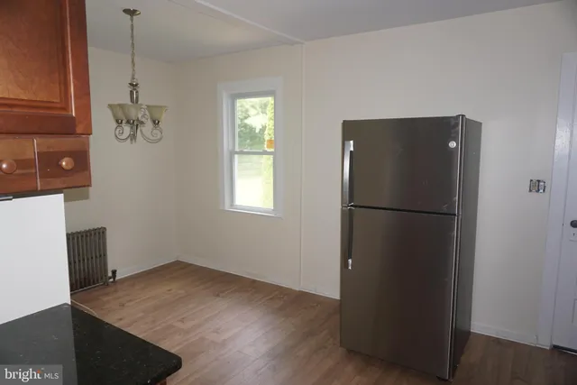 a kitchen with a refrigerator and a stove top oven