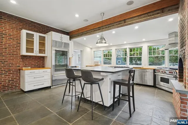 a kitchen with a table chairs stove and cabinets