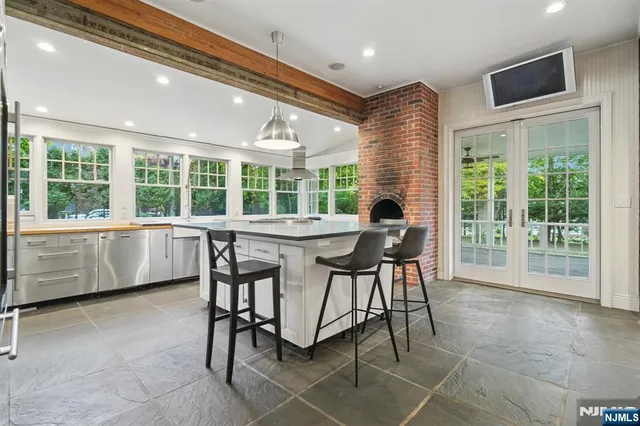 a dining room with furniture and large windows