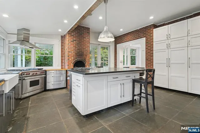 a kitchen with stainless steel appliances granite countertop a stove a sink and a refrigerator