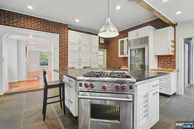 a kitchen with a stove and chairs