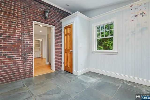 a view of a livingroom with an empty space and a window
