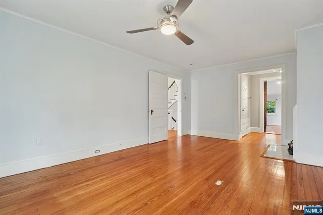a view of empty room with wooden floor
