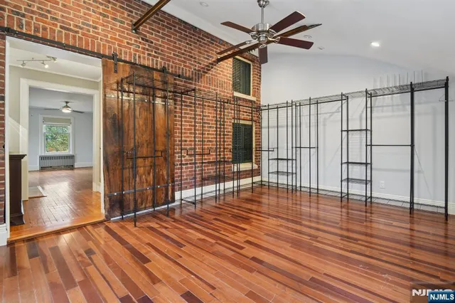 a view of empty room with wooden floor