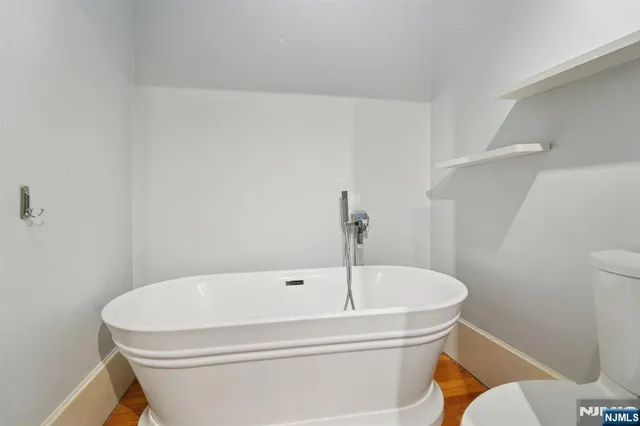 a white bath tub sitting next to a white toilet