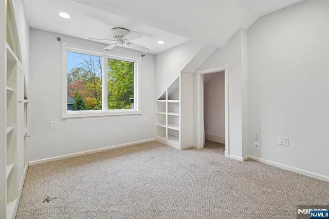 an empty room with windows and closet