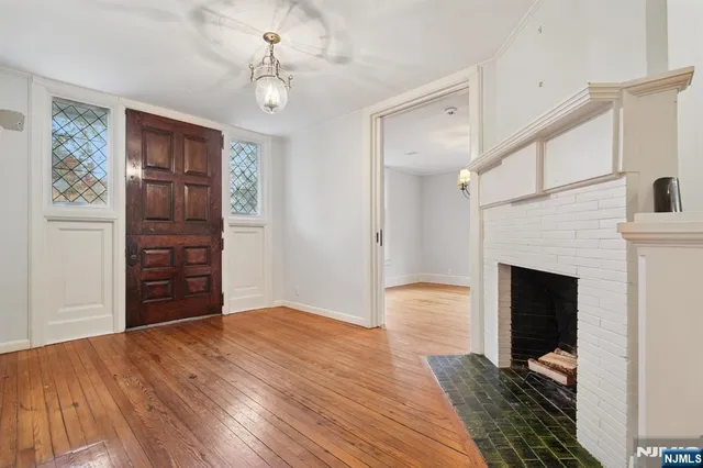a view of a livingroom with wooden floor closet and a window