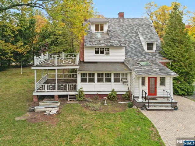 a front view of a house with a yard table and chairs