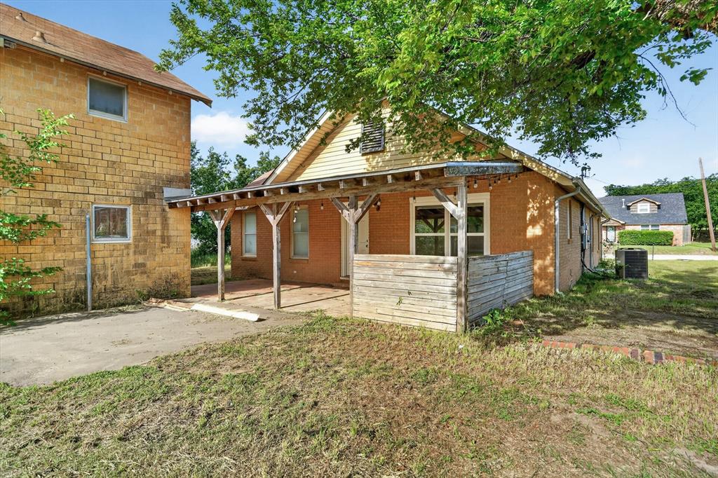 320 North 2nd Street Jacksboro, TX 76458 - Photo 16 of 16 a house with trees in the background