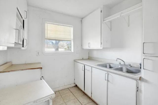 a kitchen with a sink and cabinets