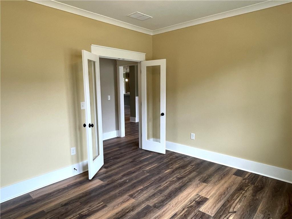 500 Mill Farm Lane Monroe, GA 30655 - Photo 14 of 35 an empty room with wooden floor and entrance