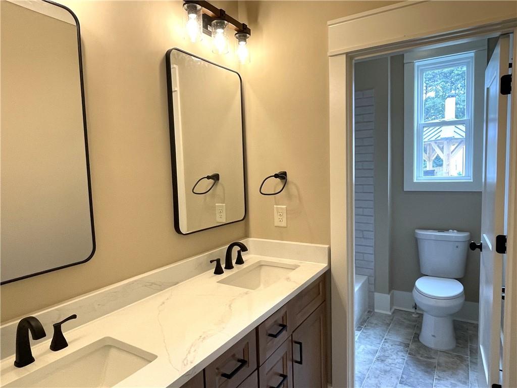 500 Mill Farm Lane Monroe, GA 30655 - Photo 20 of 35 a bathroom with a sink and mirror with toilet