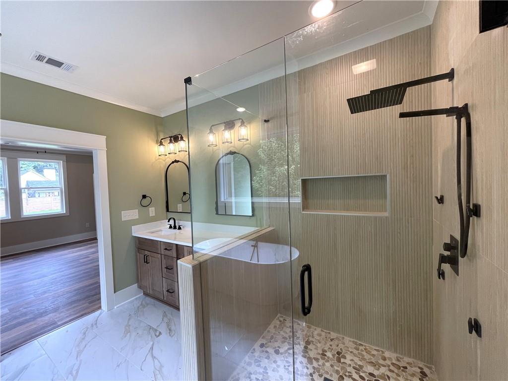 500 Mill Farm Lane Monroe, GA 30655 - Photo 26 of 35 a bathroom with a double vanity sink a mirror and shower