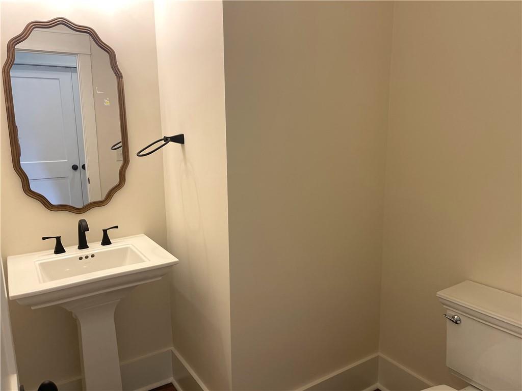 500 Mill Farm Lane Monroe, GA 30655 - Photo 30 of 35 a bathroom with a sink and a mirror