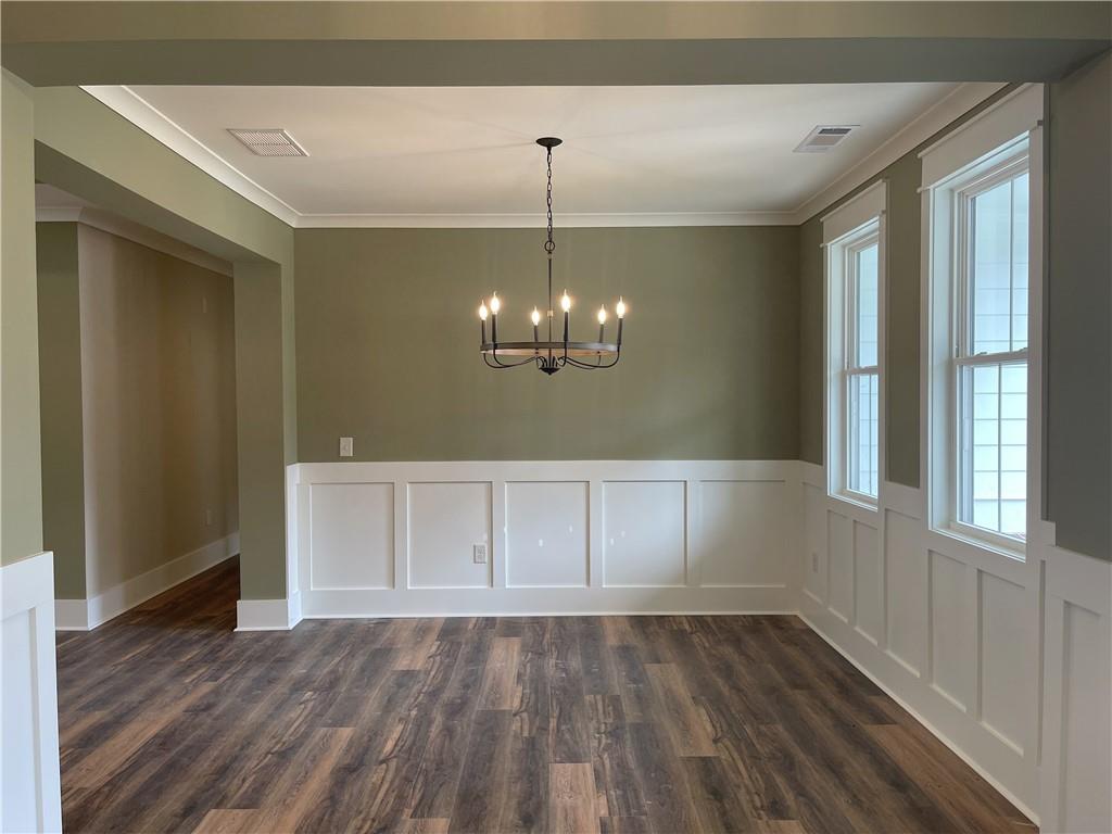 500 Mill Farm Lane Monroe, GA 30655 - Photo 4 of 35 a view of an empty room with wooden floor and a window